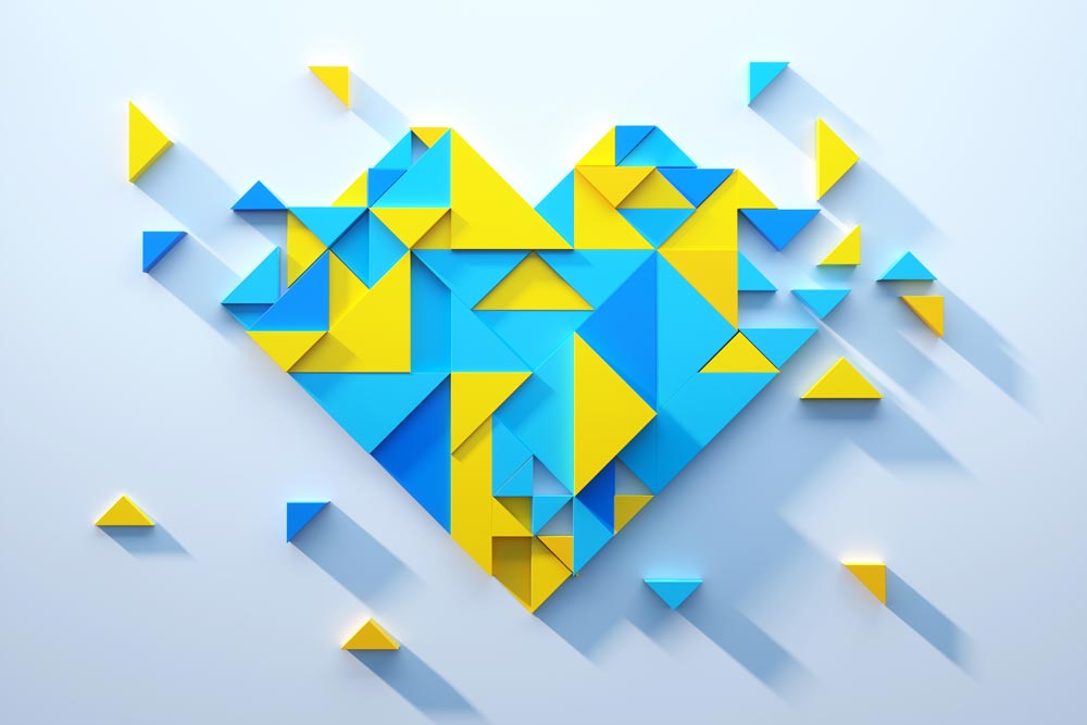Digital generated image of triangles in blue and yellow colors forming heart shape on white background. Ukraine peace and support concept